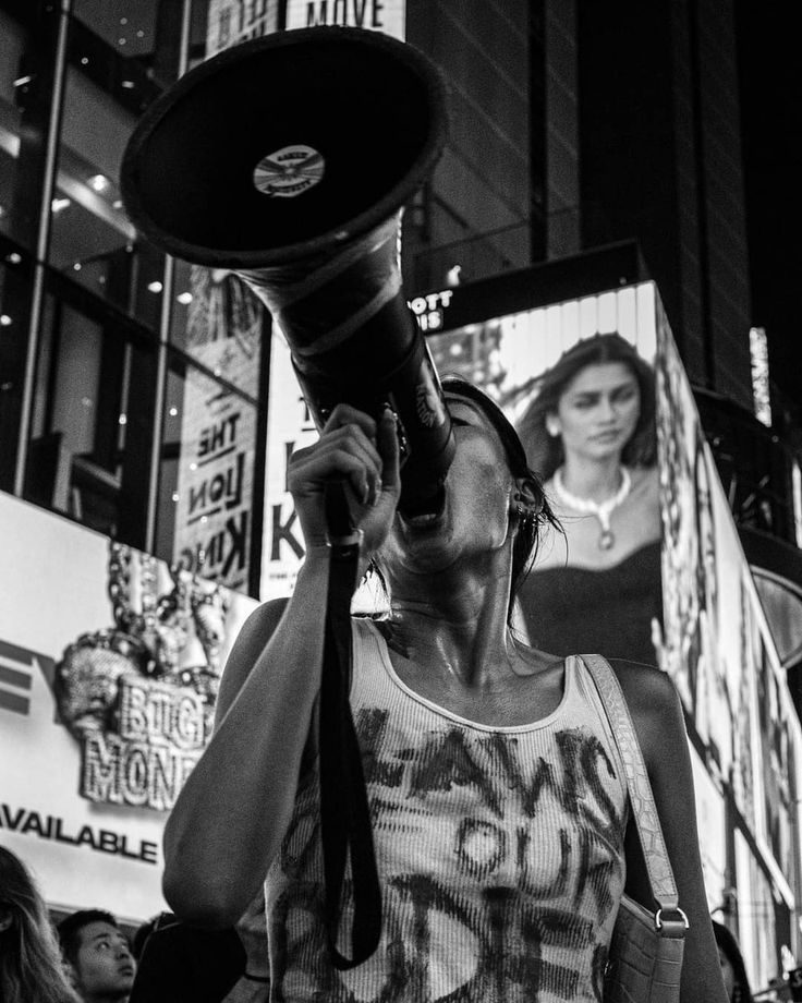 Person with a megaphone in a city crowd